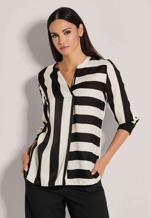 Black and white striped blouse with a V-neck, three-quarter sleeves, and a relaxed fit. Soft fabric with a sleek finish.