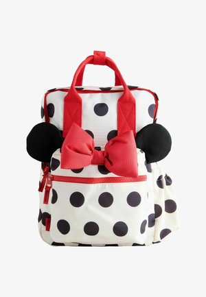 White backpack with large black polka dots, red handles, front pocket, big red bow, and two round black ears resembling a mouse.
