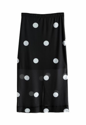 Melnā svārki ar lieliem baltiem punktiņiem. Izgatavoti no viegla auduma ar elastīgu jostasvietu. Garums sasniedz vidus teļa.