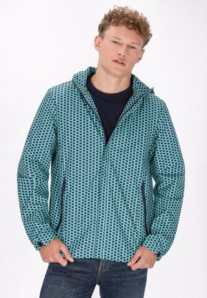 Hoody-jack met een teal en marineblauw geometrisch patroon, gemaakt van lichtgewicht materiaal, met zijzakken en een ritssluiting.
