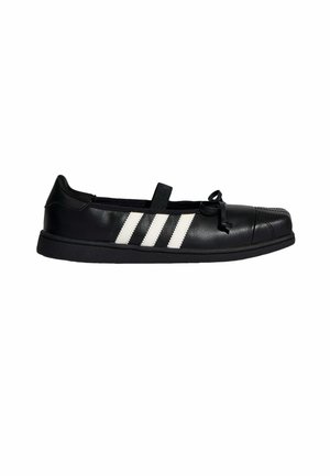 Chaussure plate en cuir noir avec des rayures blanches sur le côté, un petit nœud à l'avant, et une seule bride élastique sur le dessus.