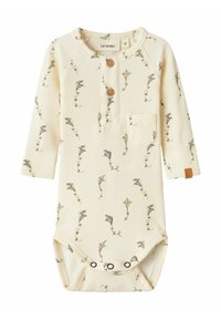 Ecrufarbenes, geripptes Baby-Overall mit langen Ärmeln, verfügt über Holzknöpfe, eine kleine Tasche und ein Drachenmuster. Enthält Druckknopfverschlüsse am Boden.