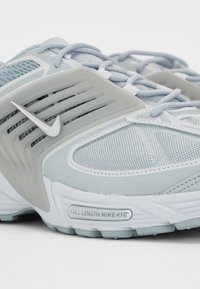 Light blue athletic shoes featuring mesh and suede materials, with white accents and a "FULL LENGTH NIKEAIR" detail on the sole.