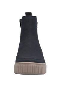 Bottines noires avec une finition lisse, détail de fermeture éclair sur le côté, et une semelle épaisse beige avec des nervures texturées.
