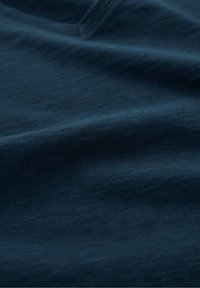 Dark blue fabric with a smooth, slightly textured surface, showcasing a subtle heather pattern, ideal for casual or active wear.