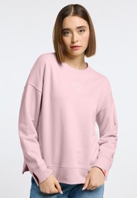 Lichtroze sweatshirt met een ronde halslijn, verlaagde schouders en geborduurd hartdetail. Katoenmix stof, comfortabele pasvorm, zijsplitten.
