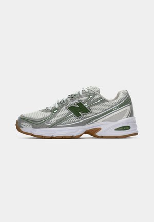 Men’s running shoes featuring a mesh upper in white with gray and green accents, a cushioned sole, and textured rubber outsole.