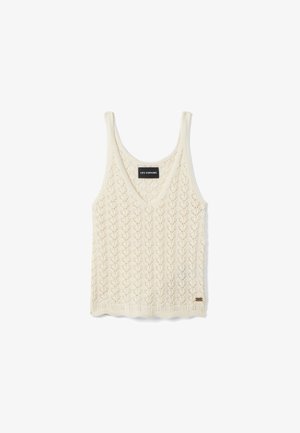 Top sin mangas de punto color crema con escote en V y patrón de zigzag calado, con la etiqueta "LES COPAINS".