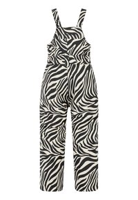 Overall met zebraprint in zwart en crème, gemaakt van katoen. Voorzien van verstelbare bandjes, een taille met riem en losse pijpen.
