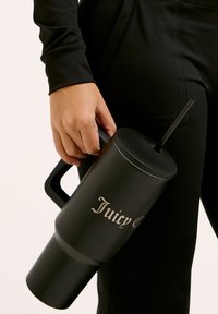 Svart isolerad mugg med handtag, sugrör och silvrig text "Juicy Couture." Slät matt yta, cylindrisk form.