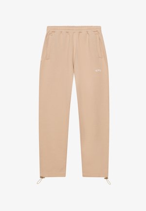 Beige sweatpants with an elastic waistband, two side pockets, and adjustable ankle cuffs. Features white text logo on the front.