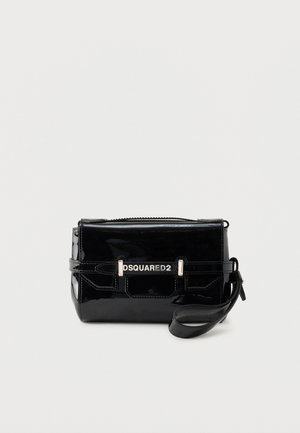 Glossy black rectangular wristlet bag with folded flap, silver "DSQUARED2" logo plaque, and attached wrist strap on a plain background.