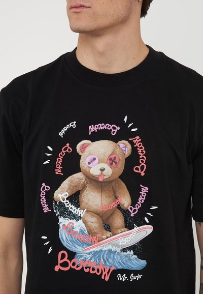 Bear with button eyes surfing on a wave, surrounded by repeated "Borrow" text in various colors on a black t-shirt.