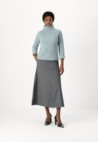 Light blue ribbed turtleneck sweater paired with a long gray skirt. Black high-heeled shoes, smooth texture, and tailored design.