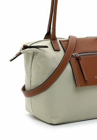 Gray and brown synthetic handbag with a slouchy design, featuring a brown leather accent and zippered pockets, sturdy straps with white stitching.