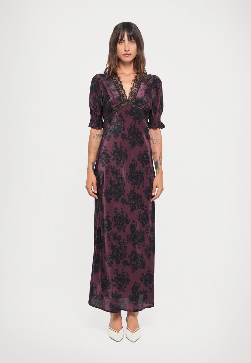 Long, dark purple dress with black floral pattern, deep V-neck, puffed sleeves, and lace trim. Smooth fabric with a flowy silhouette.