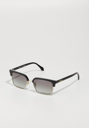 Black rectangular sunglasses with gradient lenses and gold accents, featuring a bold frame design and a logo on the side of the temple.