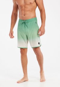 Groene verloopzwemshorts met een gestructureerd patroon, trekkoordsluiting en contrasterende afwerking. Geen zakken, lichtgewicht stof.