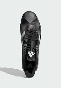 Černá sportovní bota s geometrickým vzorem na povrchu, texturovaným svrškem, stříbrnými akcenty a kontrastní černou vnitřní podšívkou.