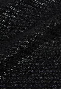 Black fabric featuring a sequin pattern with shimmering, circular designs. The texture appears smooth and glossy, with a slight drape.