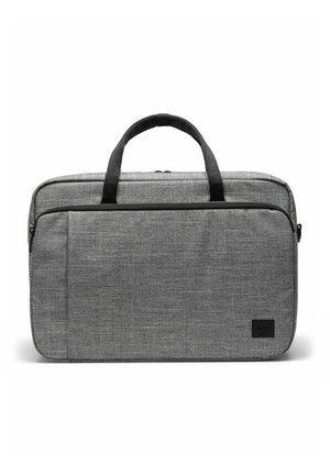 Sacoche pour ordinateur portable en tissu gris avec poignées noires, poche frontale zippée, et forme rectangulaire compacte conçue pour transporter des appareils électroniques.