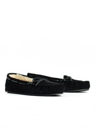Zwarte moccasin pantoffels van suède, met een zachte, met bont gevoerde binnenkant, gestikte details en een strikaccent aan de voorkant.