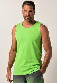 Green tank top made of cotton, featuring a crew neckline and sleeveless design. Smooth texture with subtle branding on the chest.