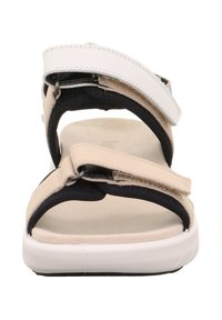 Beżowo-czarna sandałka z dwoma regulowanymi paskami, zapięciami na rzep oraz lekką podeszwą, wyposażona w wyściółkę i teksturowany bieżnik.