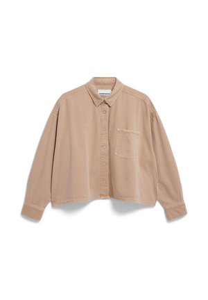 Cropped beige button-up shirt made of soft fabric, featuring a pointed collar, single chest pocket, and stitched detailing on seams.