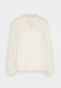Blouse à manches longues, couleur crème, avec un motif floral texturé. Dotée d'un col mandarin, d'une fermeture à boutons et de poignets élastiques.