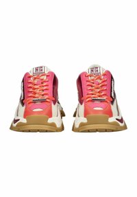 Sneakers with a mix of pink and red hues, mesh and leather materials, chunky beige sole, and prominent laces and branding details.
