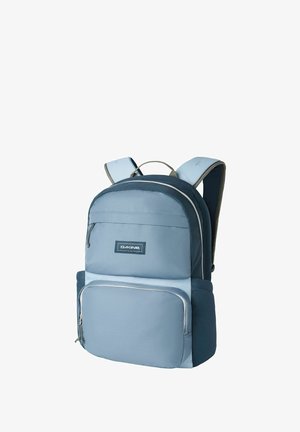 Light blue padded backpack with multiple zippered compartments, adjustable shoulder straps, and Dakine logo on front pocket.
