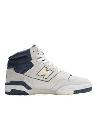 High-top sneaker in gray suede and navy accents. Features a textured upper, perforated details, and a rubber sole with a white midsole.