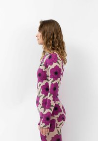 Long-sleeve bodysuit with purple floral print on a beige background, featuring a round neckline and form-fitting design.