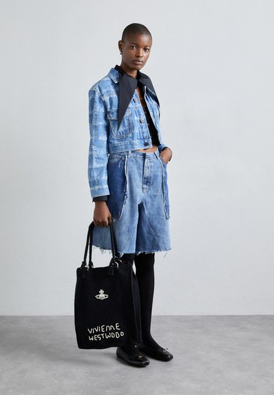 Denim cropped jacket with blue and white patterns, paired with matching denim shorts. Black bag with "Vivienne Westwood" text and silver hardware.
