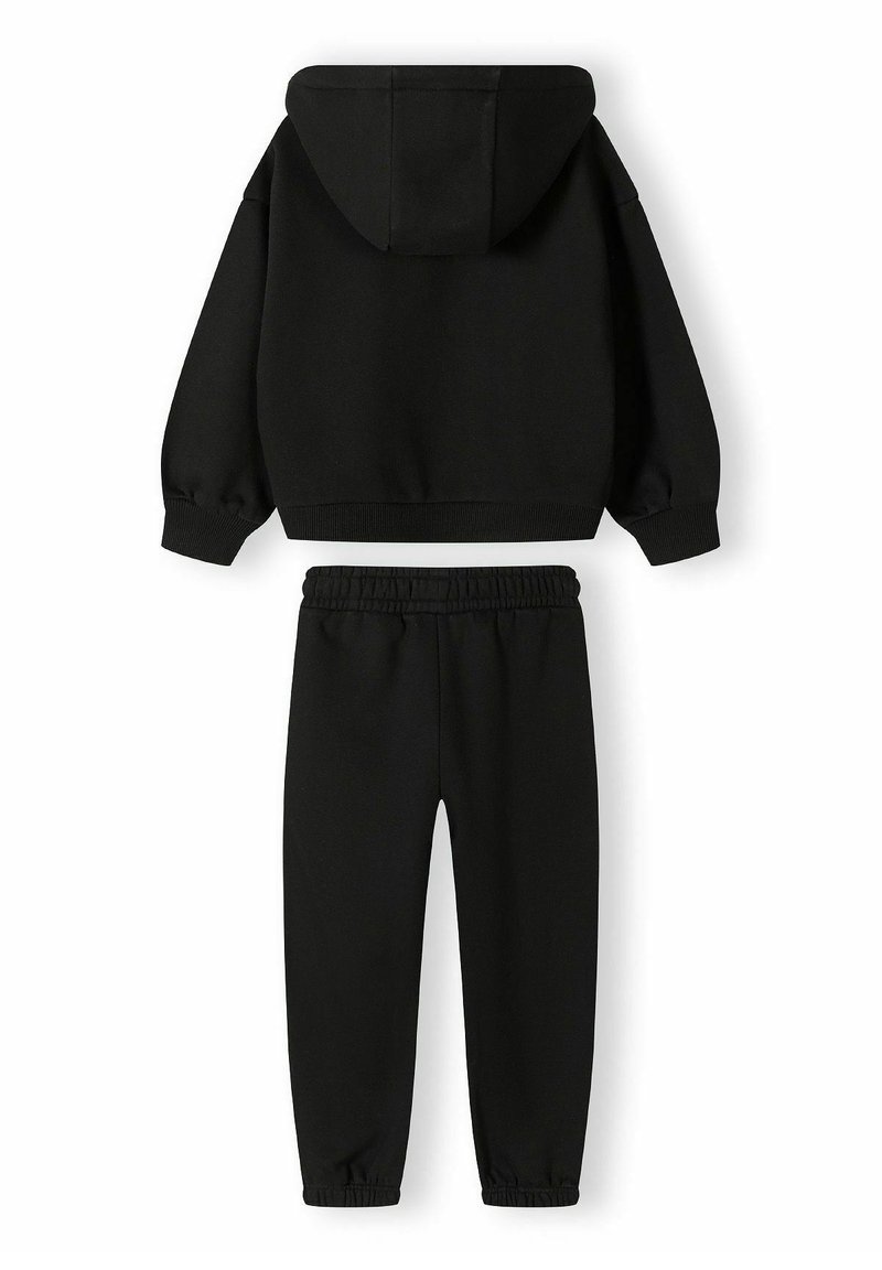 Ensemble de sweat à capuche noir et de pantalon. Le sweat à capuche comporte une capuche avec cordon de serrage et des poignets côtelés. Les pantalons ont une taille élastique et des jambes fuselées. Texture douce.