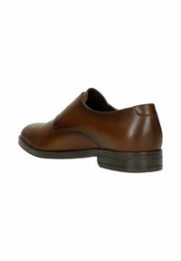 Scarpa in pelle marrone con punta rotonda, pannello laterale elastico, tacco basso e dettagli di cucitura discreti sulla tomaia. Texture complessivamente liscia.