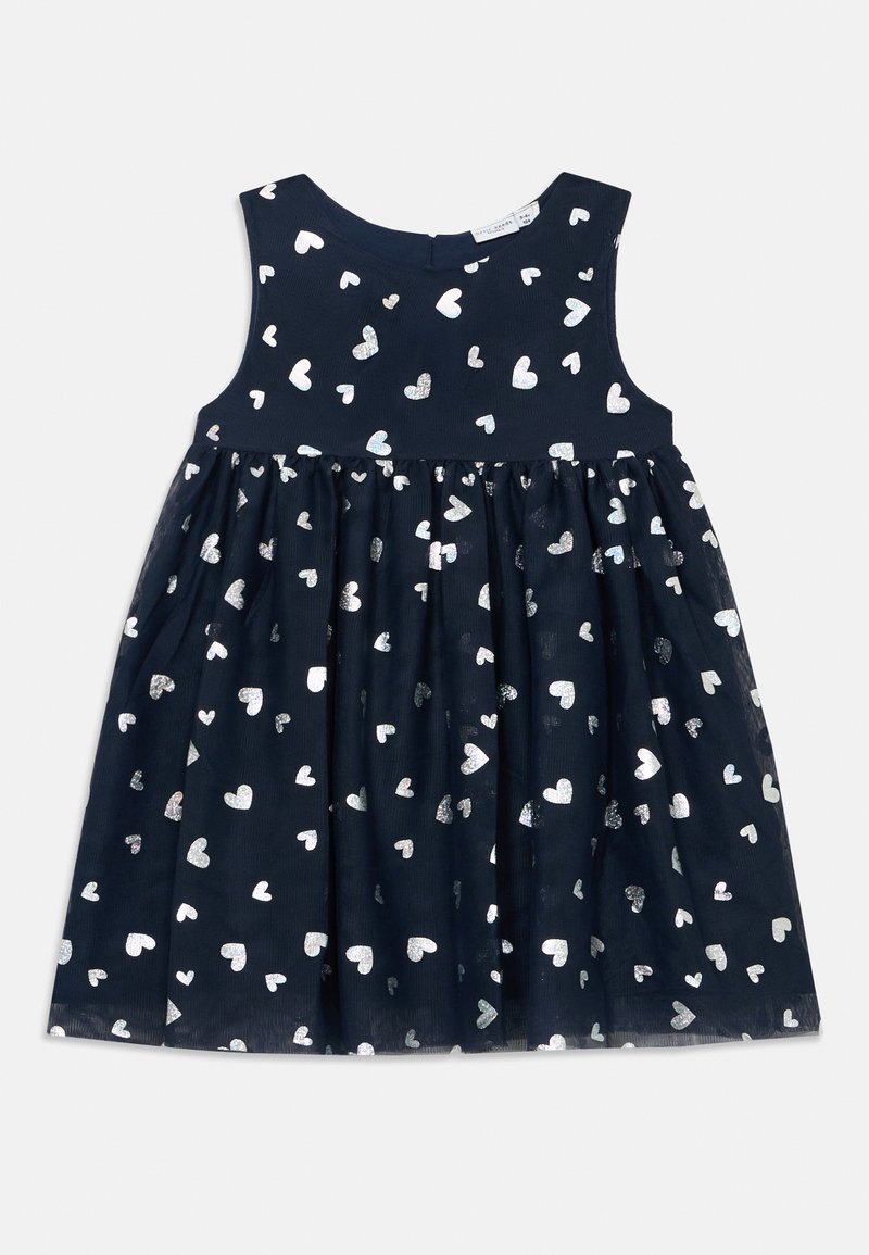 Mornarice plava haljina s pripijenom bezrukavom korzetom i raširenom suknjom, ukrašena sjajnim srebrnim uzorcima srca.