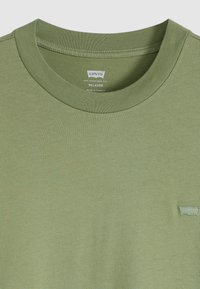 T-shirt verde oliva dalla vestibilità comoda con scollatura rotonda e colletto a costine; presenta un piccolo logo ricamato di Levi's sul lato sinistro del petto.