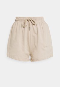 Shorts beige avec une ceinture élastique et un cordon de serrage. Confectionnés dans un tissu doux, ils présentent une coupe ample et un ourlet tombant au milieu de la cuisse.