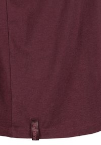 Maroon cotton t-shirt with a soft texture. Features a side seam and a label at the hem with "SUBLEVEL" in contrasting color.