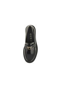 Mocassino in pelle lucida nera con fibbia in metallo dorato a forma di G sulla parte superiore e il marchio "GUESS" all'interno della scarpa.