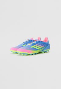Bright blue soccer cleats with pink and green accents. Material appears synthetic, featuring textured patterns and rounded toe design.