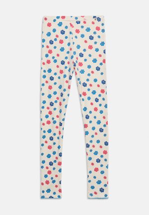 Children's white leggings with an all-over pattern of small blue, navy, and pink flowers.