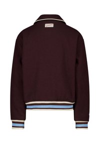 Burgundy fleece jacket with a white collar and striped ribbed cuffs in blue and cream. Features a label on the upper back.