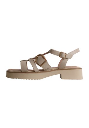 Sandale beige à bout ouvert avec deux boucles dorées, semelle épaisse et petit talon bloc, avec plusieurs brides et une bride à la cheville.