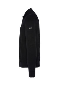 Svart stickad tröja med hög krage, långa ärmar och ribbad fåll. Har en liten logotyp på vänster ärm.