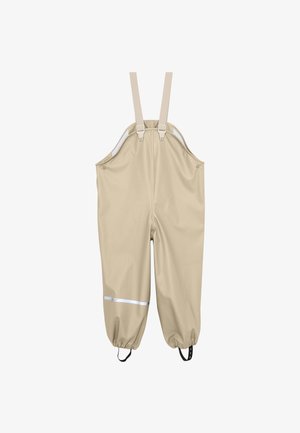 Pantalones tipo peto impermeables de color beige con tirantes ajustables en los hombros, tobillos elásticos, correas para los pies y una tira reflectante en la pierna izquierda.
