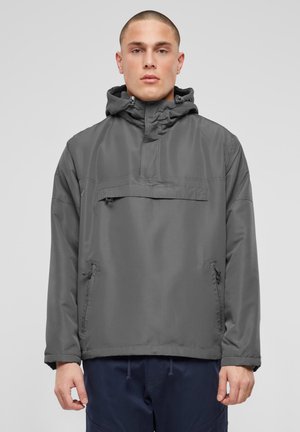 Veste pull grise avec capuche, poche avant et zips latéraux. Tissu lisse et léger ; col et poignets ajustables pour un meilleur ajustement.