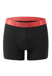 Black boxer shorts with a red elastic waistband featuring the word "FREEDOM" repeated. Smooth fabric, fitted design, and no visible patterns.